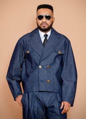 The Tessletic Marshal Set reimagines denim through the language of tailored authority. Cut in rich indigo cotton denim with clean architectural lines, this elevated set pairs a structured double-breasted jacket with relaxed pleated trousers for a look that feels equally athletic, refined, and commanding. Designed for the modern man who moves between influence, leisure, and presence with ease.