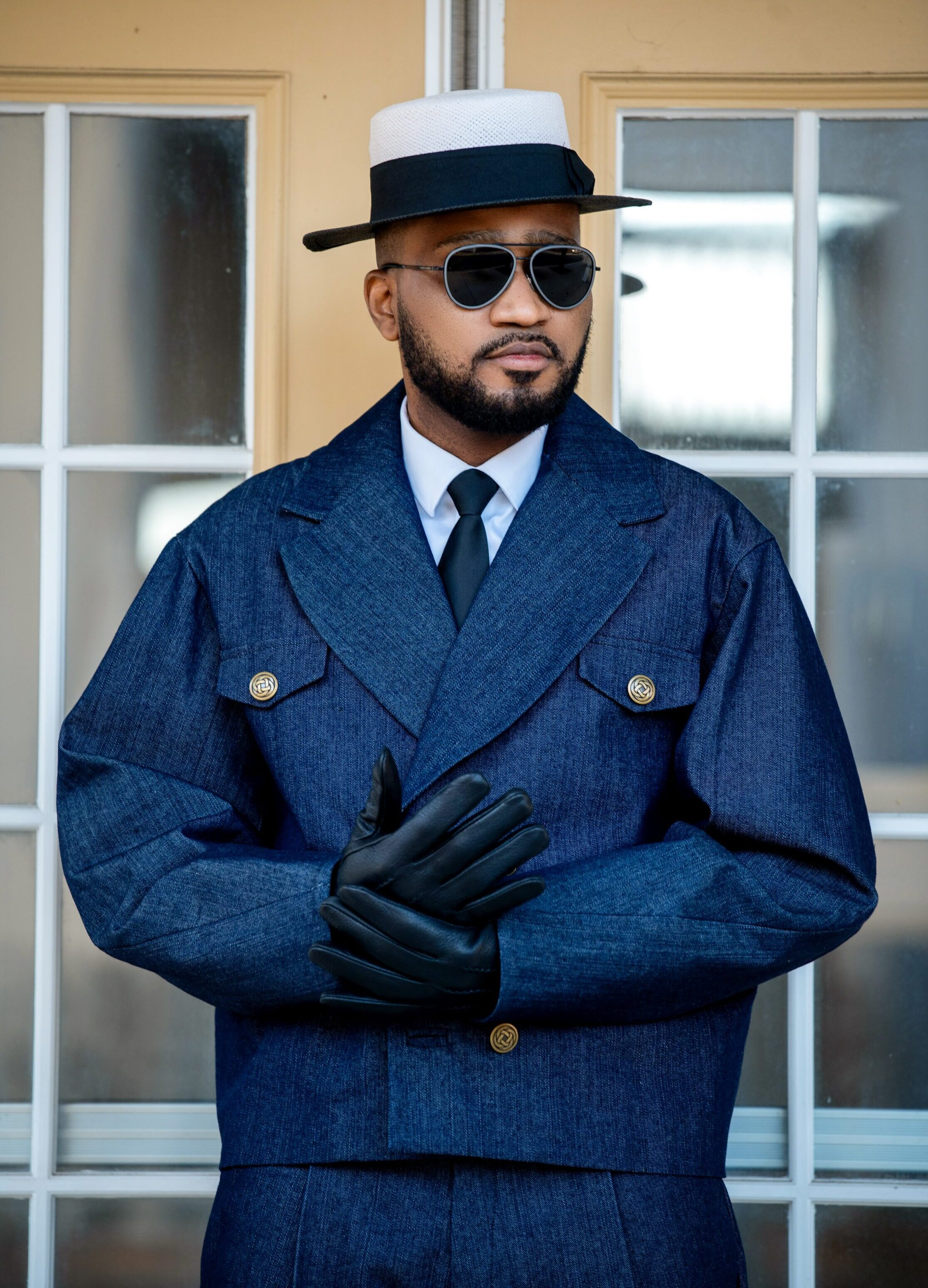 The Tessletic Marshal Set reimagines denim through the language of tailored authority. Cut in rich indigo cotton denim with clean architectural lines, this elevated set pairs a structured double-breasted jacket with relaxed pleated trousers for a look that feels equally athletic, refined, and commanding. Designed for the modern man who moves between influence, leisure, and presence with ease.