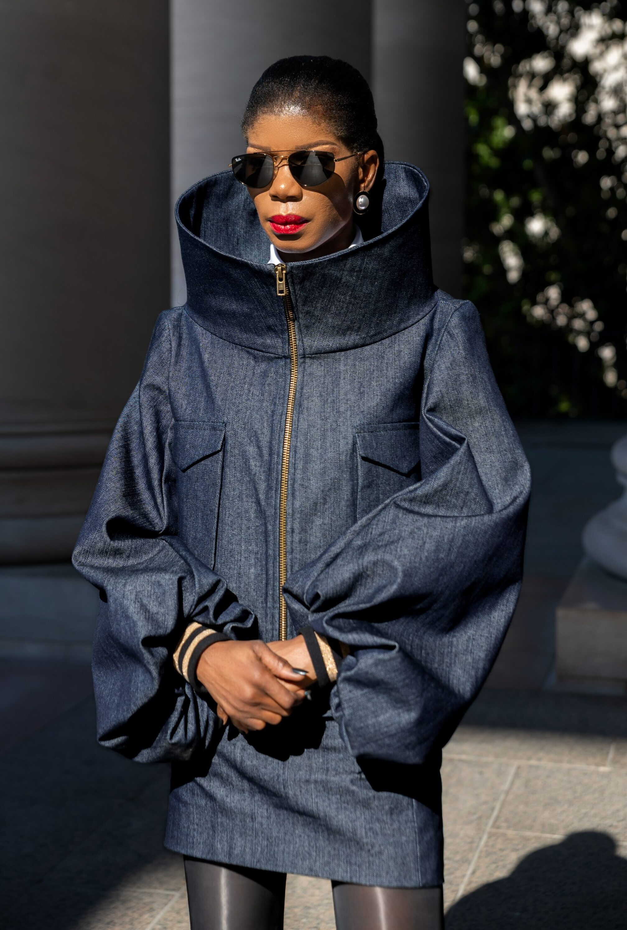 The Tessletic Max Set reimagines denim through sculptural luxury. As the debut women’s piece in the Tessletic series, it merges tailored structure with athletic ease, equally suited for elevated daywear, travel, or evening styling. Crafted in rich cotton denim, the jacket features a dramatic sculpted collar that transforms with wear. Fully zipped, it creates a bold architectural silhouette; worn open, it softens into a more relaxed elegance, offering two distinct looks in one piece. The coordinating denim mini skirt sharpens the silhouette while maintaining versatility and ease.