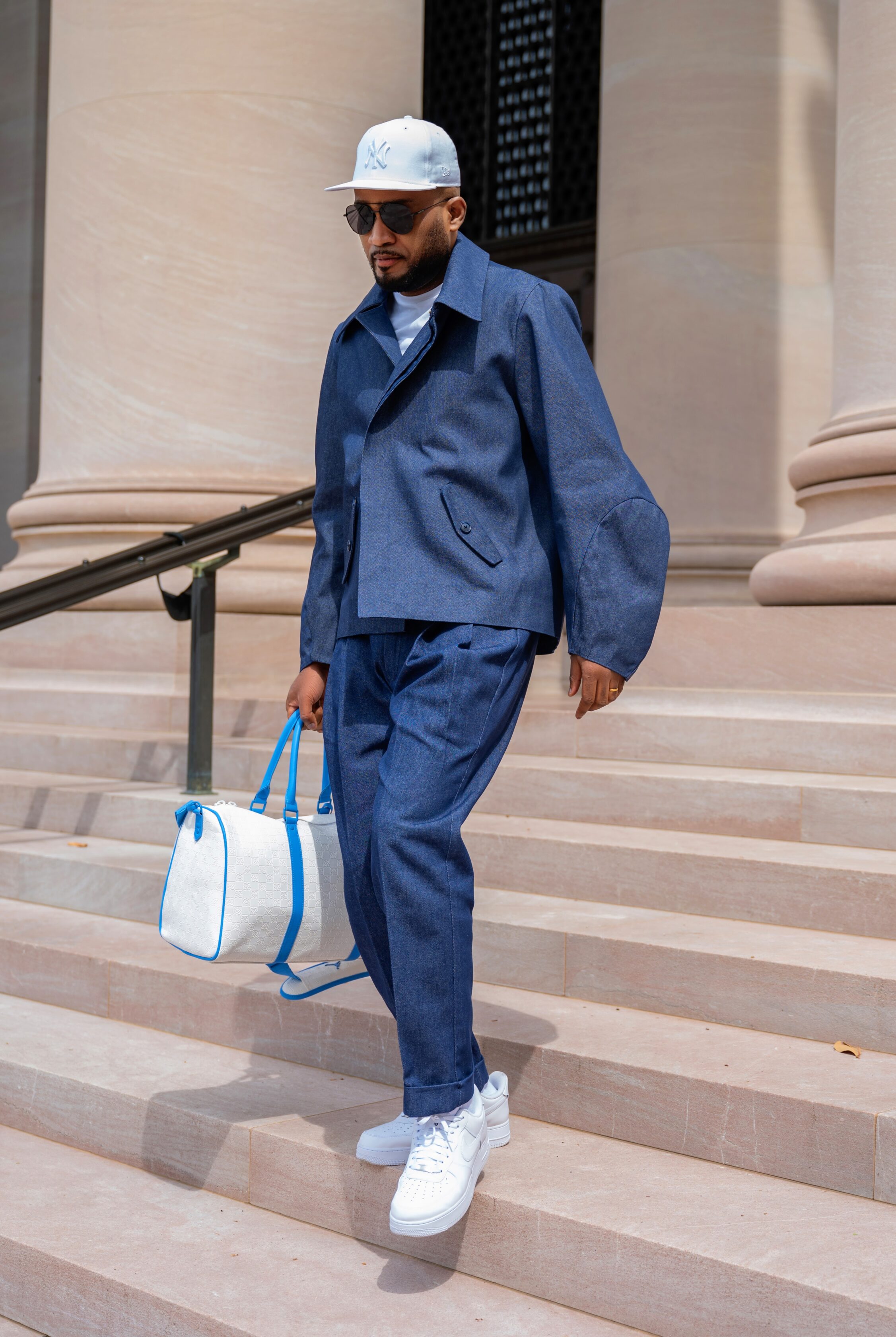The Tessletic Indigo Set reimagines modern menswear through the lens of luxury sport and elevated tailoring. Centered around the signature Sphinx Jacket from the Tesslo Just Jackets collection, the look pairs sculptural outerwear with pleated indigo denim trousers for a refined yet effortless statement.