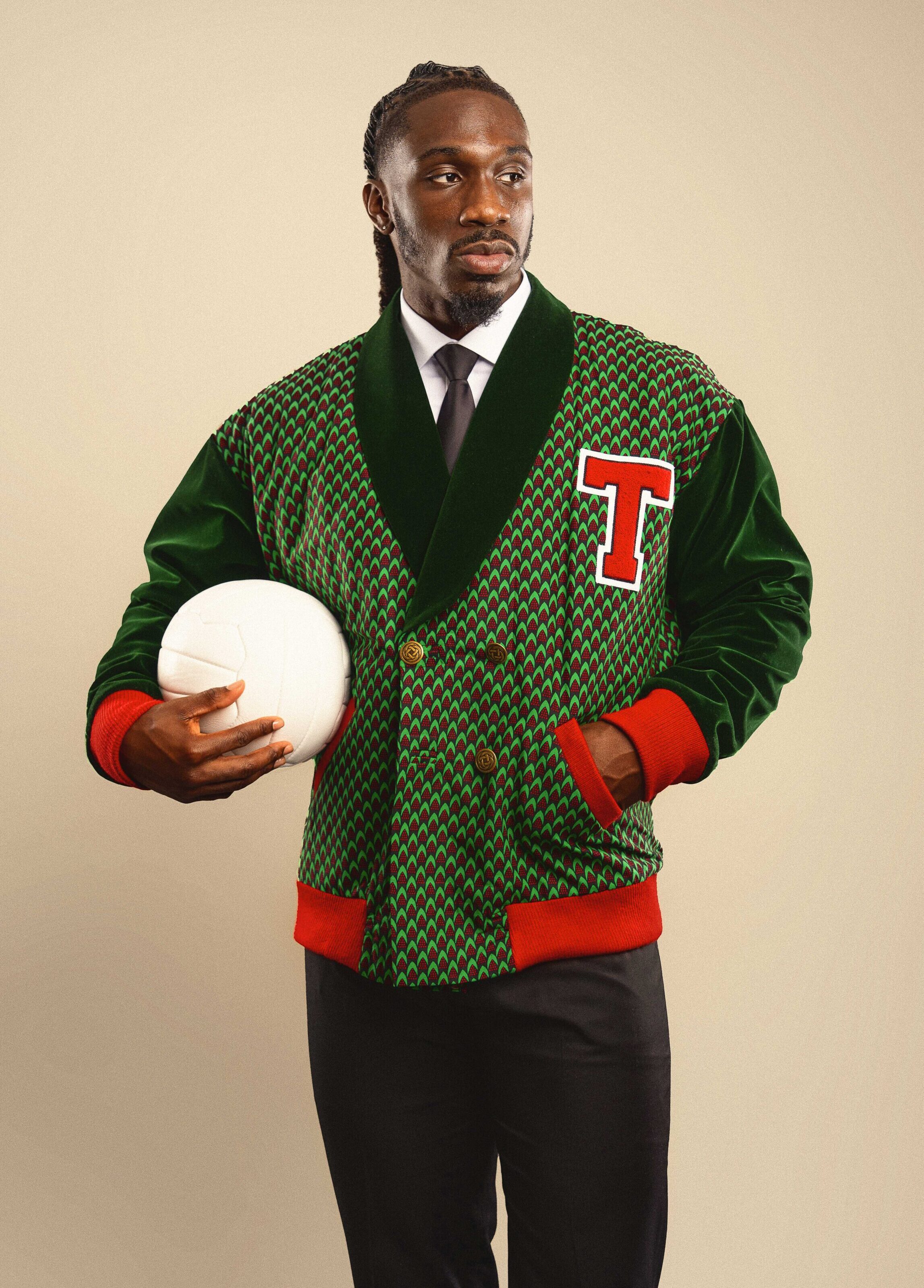 The Atlético celebrates the prestige of athletic talent and the spirit of champions. Inspired by classic varsity style and designer Tessy Oliseh-Amaize’s football family heritage, it bridges the worlds of sport and style. Handmade in the USA with cotton Ankara fabric and plush velvet, this double-breasted jacket is designed for the man who values both performance and presence.