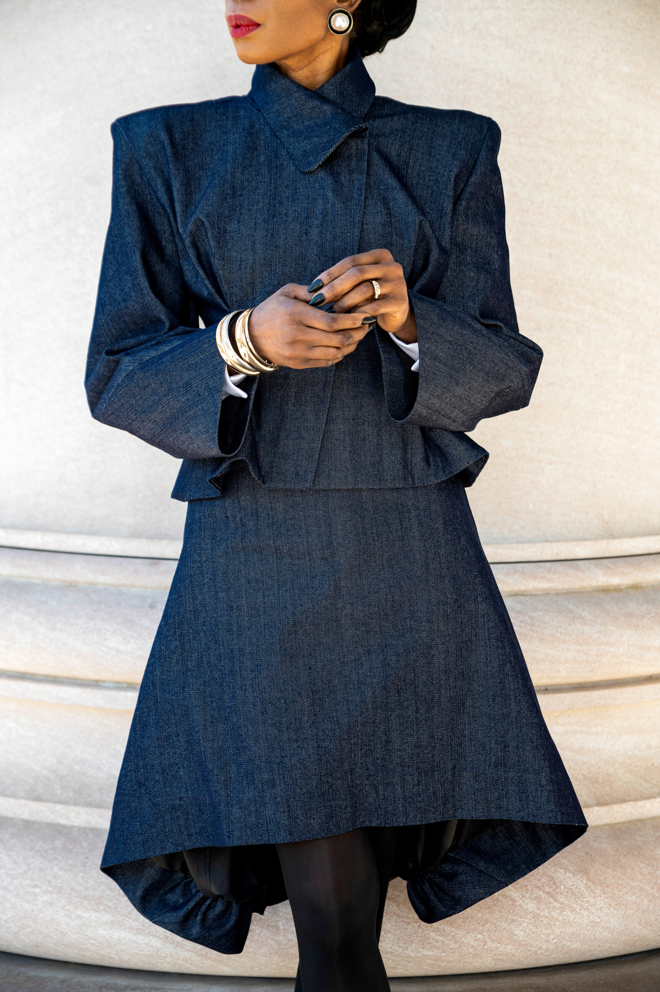 The Tesslo Audrey pairs an architectural cropped jacket with an asymmetric skirt, creating a silhouette that is both powerful and refined. Handmade with precision, every seam is designed to flatter the body while making a subtle statement.